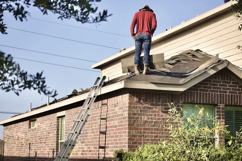 Professional roofer working on a residential roof in Mendota